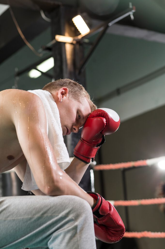 Tired boxer wearing boxing gloves